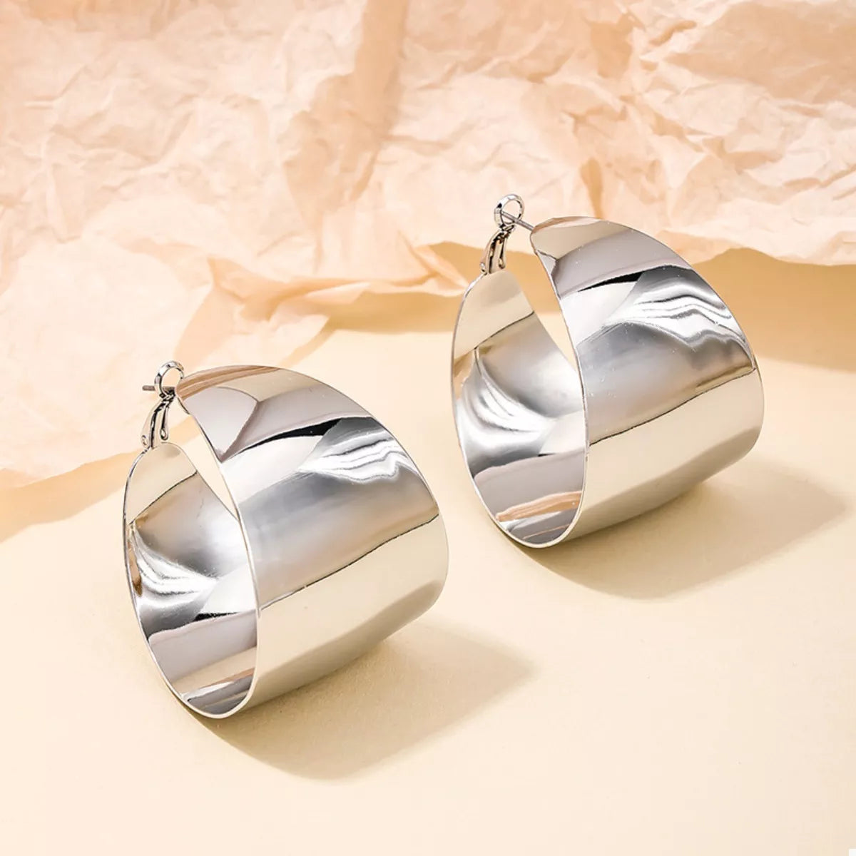 Wide Gold Hoop Earrings for Women displayed on a model.
