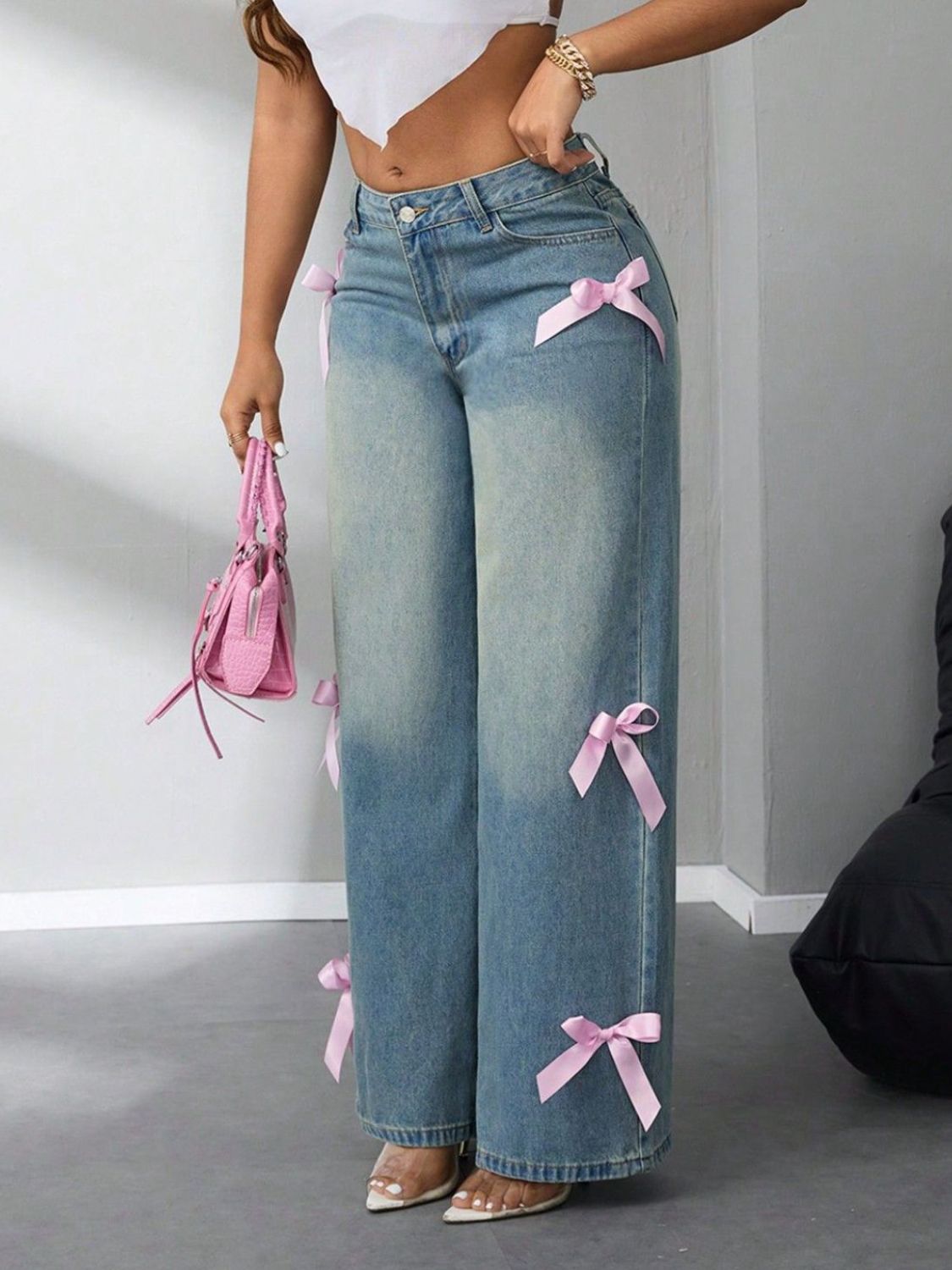 Chic bow-accent wide-leg jeans for women, available in multiple sizes and washes.