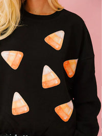 Spooky Halloween Sequin Sweatshirt showing the reversible design from black with orange sequins to orange with black sequins.