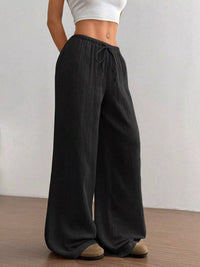 Women's plus size cotton drawstring wide leg pants in Black, showing relaxed fit and tie waist.