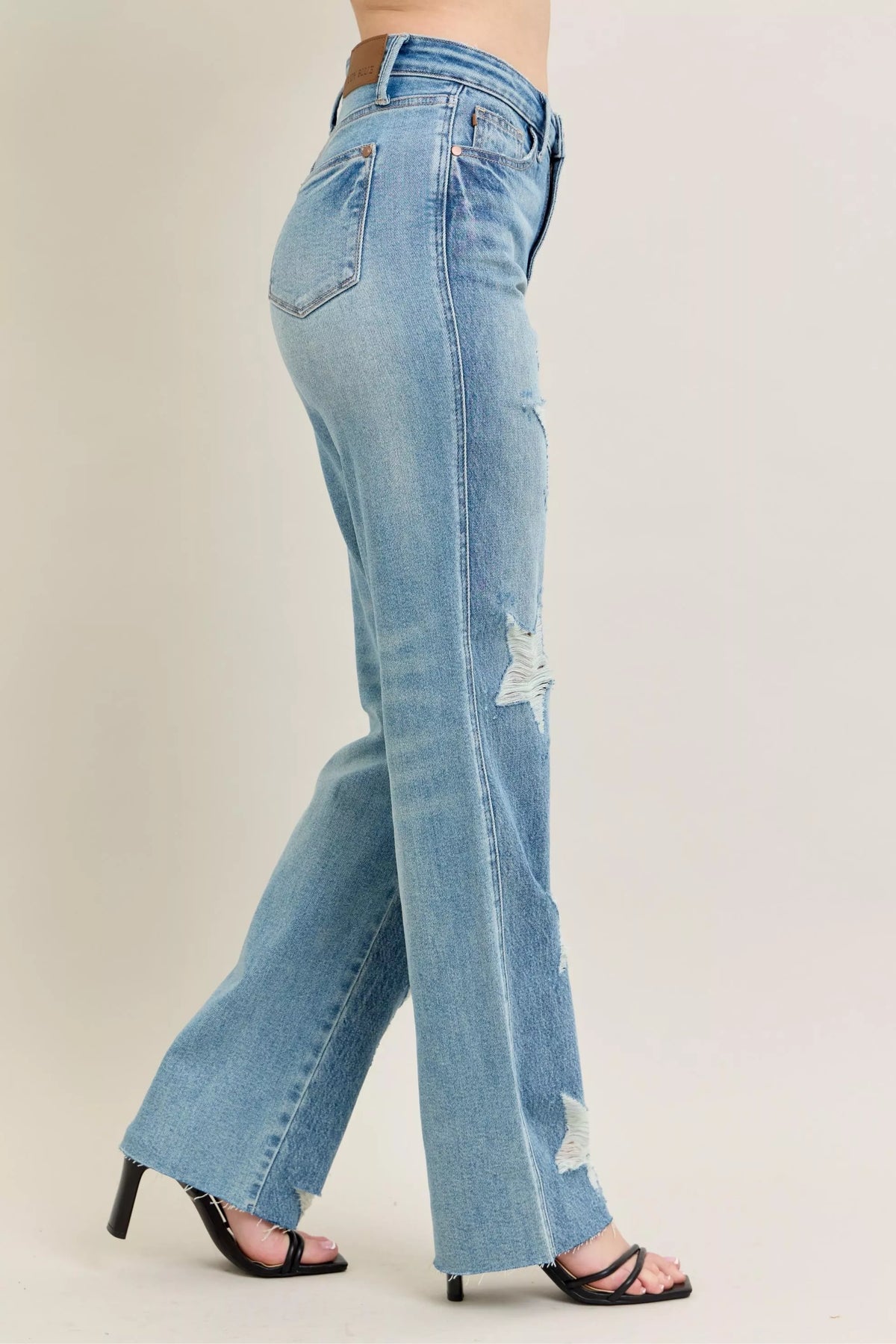 Judy Blue 90s Straight Jeans in a distressed wash, modeled from the front, showing the high waist and straight leg fit.