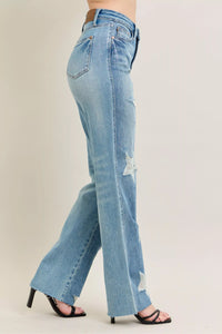 Judy Blue 90s Straight Jeans in a distressed wash, modeled from the front, showing the high waist and straight leg fit.
