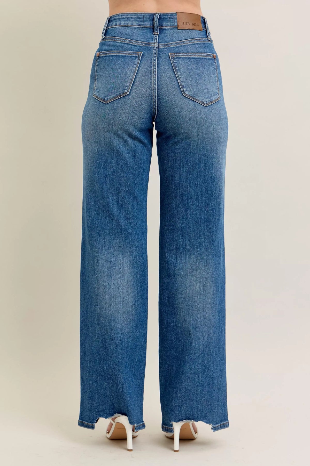 High Waist Tummy Control Jeans with Destroyed Hem on a plus-size model.