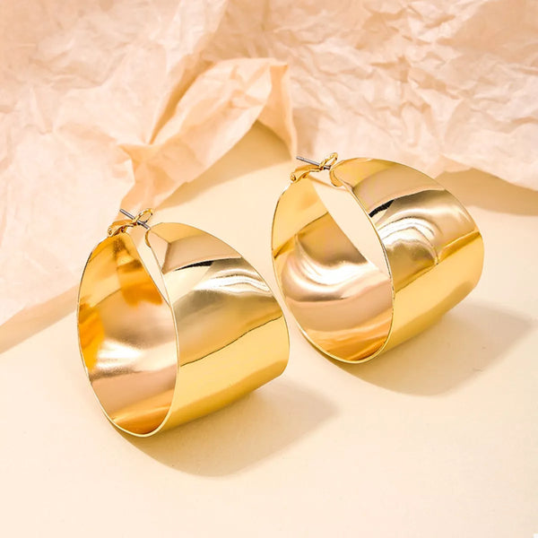 Wide Gold Hoop Earrings for Women displayed on a model.