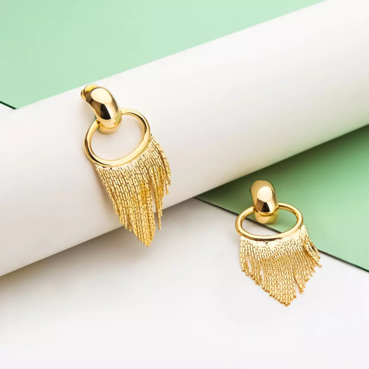 18K Gold Plated Fringe Chain Earrings dangling from a model's ear, showcasing the elegant gold finish and dynamic movement.
